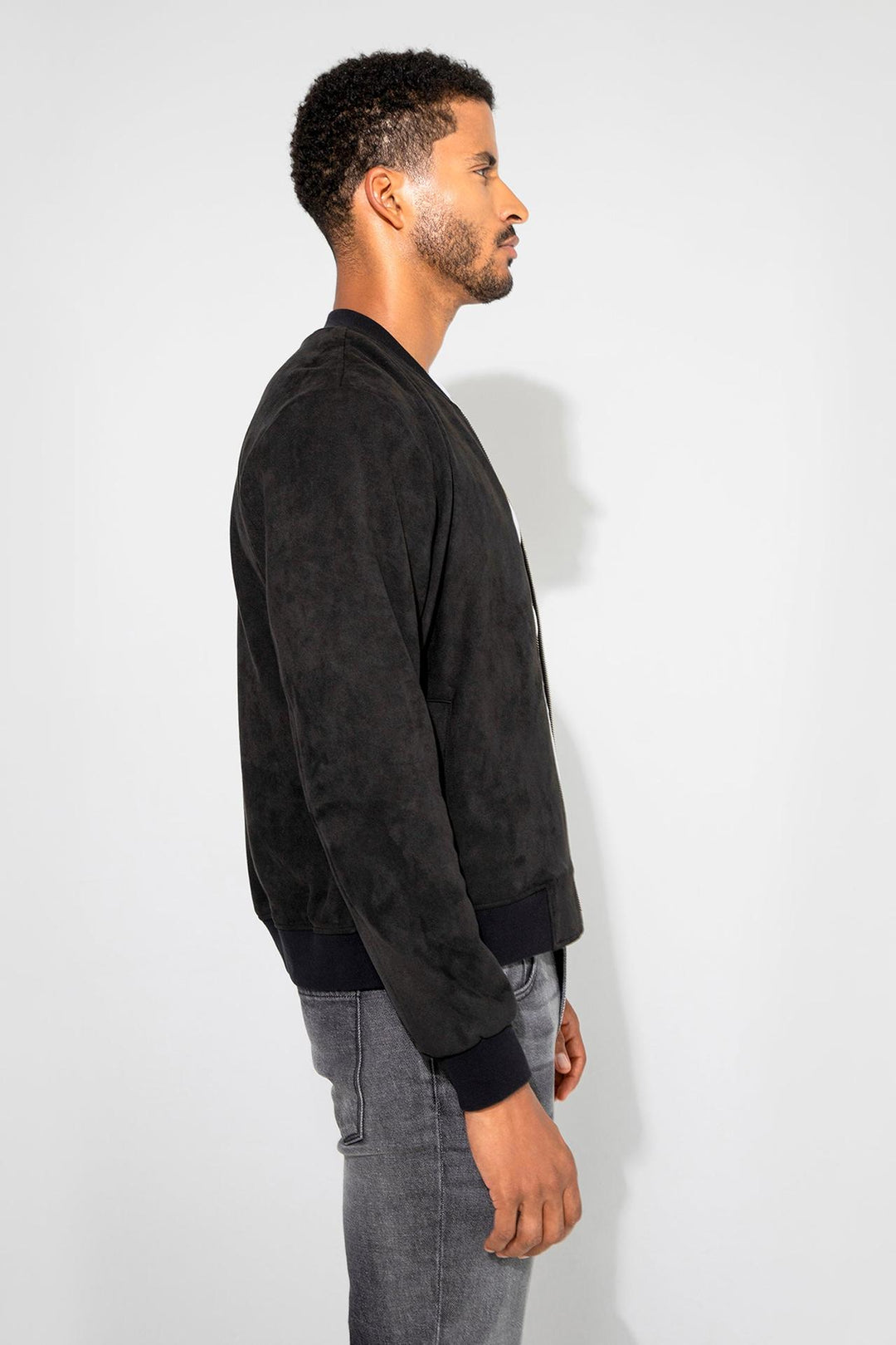 Side profile of MONFRÈRE Maverick Butter Suede Noir men's black soft faux suede stretch fabric bomber jacket.