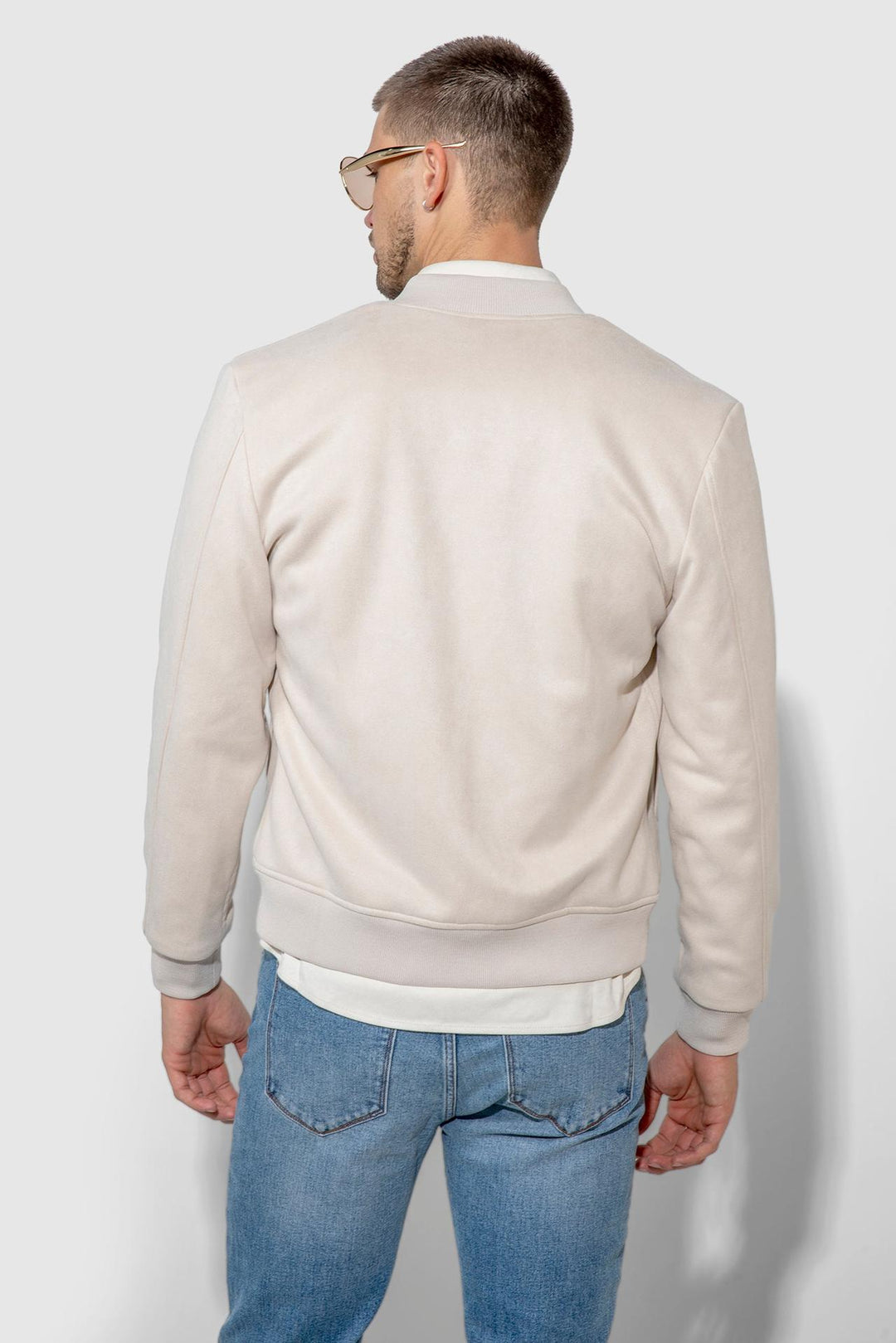 Back profile of MONFRÈRE Maverick Butter Suede Taupe men's taupe off white ivory soft faux suede stretch fabric bomber jacket.