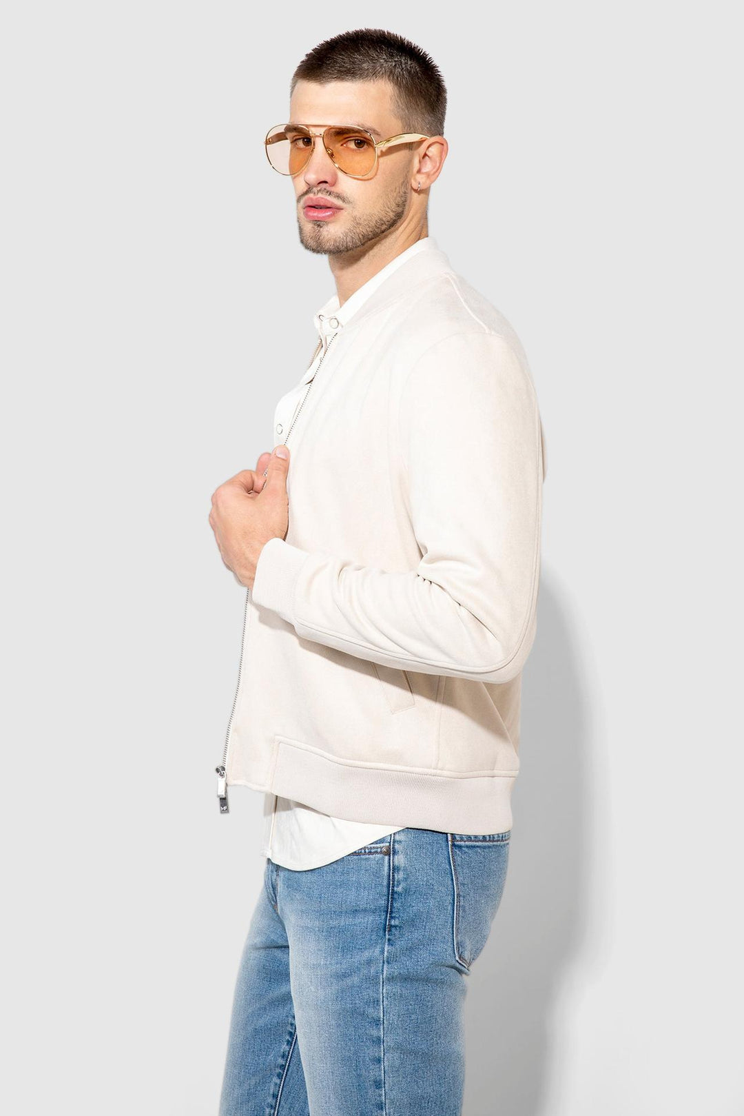 Side profile of MONFRÈRE Maverick Butter Suede Taupe men's taupe off white ivory soft faux suede stretch fabric bomber jacket.
