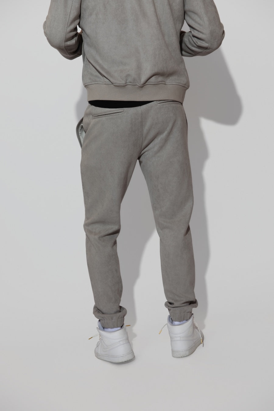 Back profile of MONFRÈRE Noah Butter Suede Cool Grey men's blue soft faux suede stretch fabric sweatpant jogger.