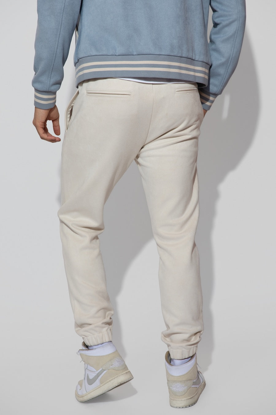 Back profile of MONFRÈRE Noah Butter Suede Ivory men's off white ivory soft faux suede stretch fabric sweatpant jogger.