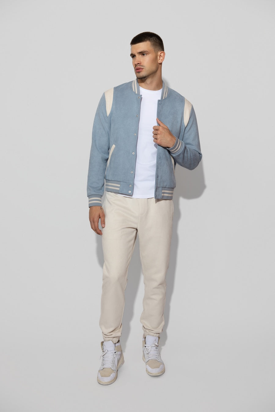 Model wearing MONFRÈRE Noah Butter Suede Ivory men's off white ivory soft faux suede stretch fabric sweatpant jogger.