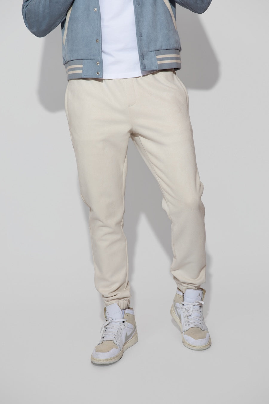 Front profile of MONFRÈRE Noah Butter Suede Ivory men's off white ivory soft faux suede stretch fabric sweatpant jogger.