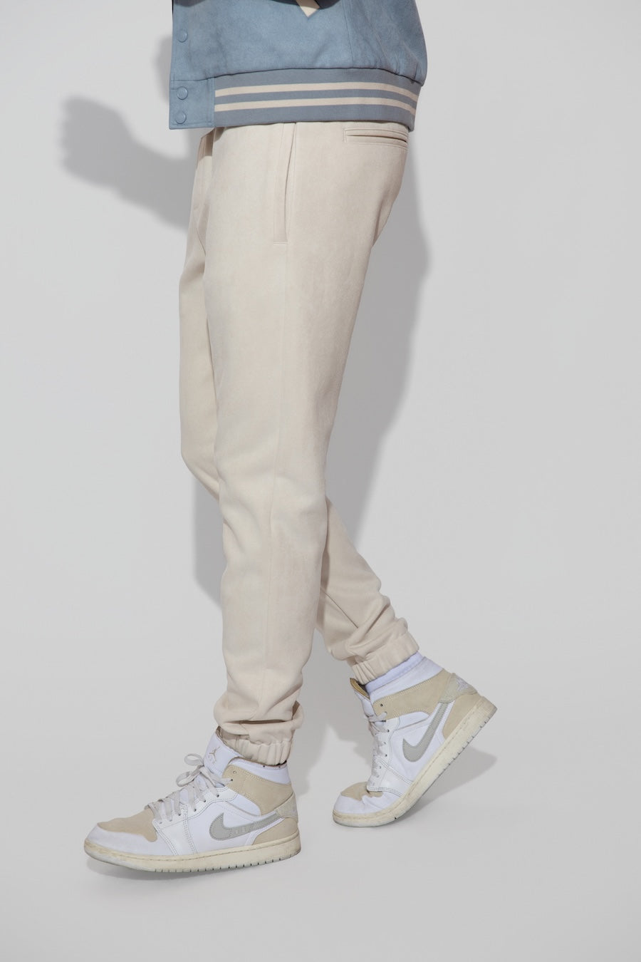 Side profile of MONFRÈRE Noah Butter Suede Ivory men's off white ivory soft faux suede stretch fabric sweatpant jogger.