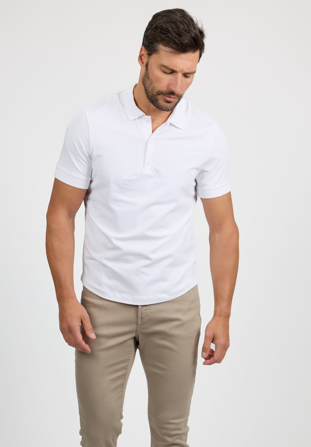 Model wearing MONFRÈRE Pierce Blanc men's white stretch jersey knit polo shirt.