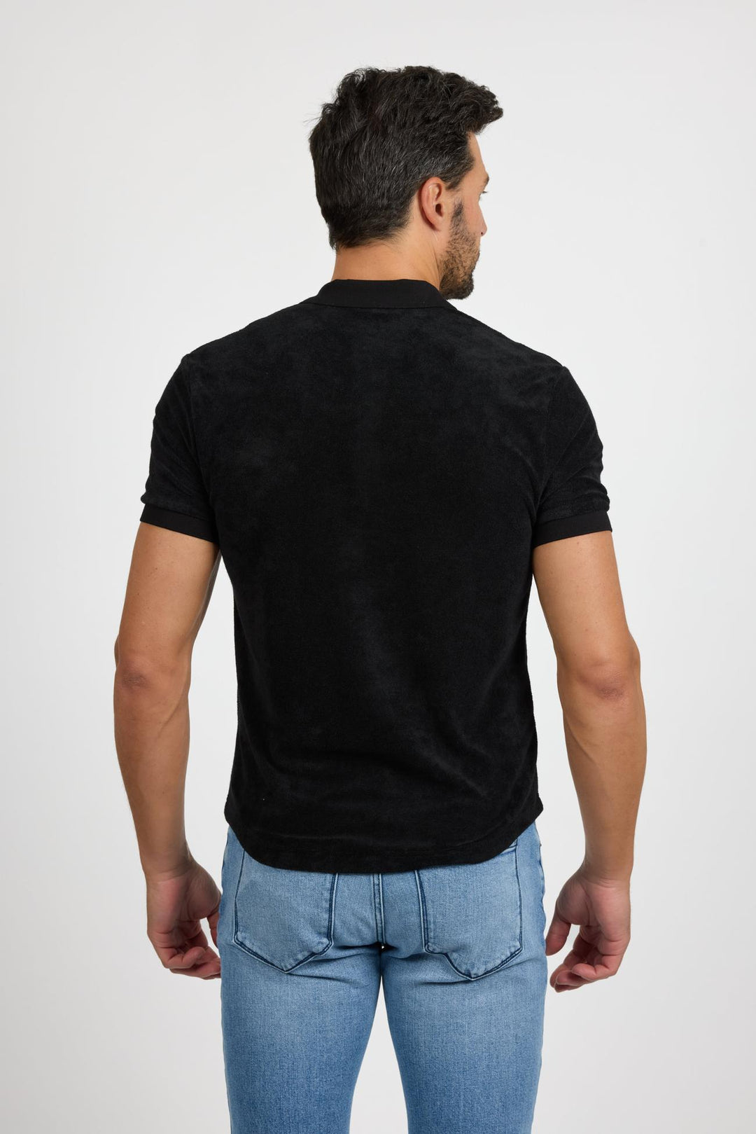 Back profile of MONFRÈRE Pierce Noir men's black stretch jersey knit polo shirt.
