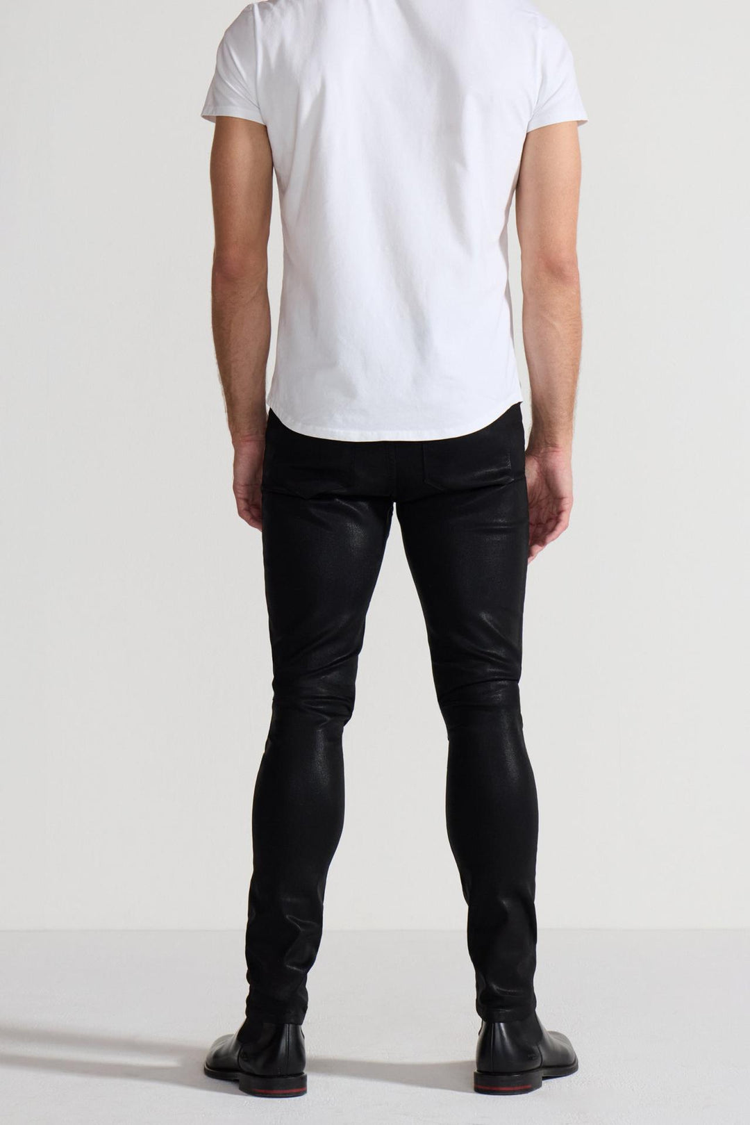 Back profile of MONFRÈRE Preston Coated Noir men's black coated stretch sateen tencel twill skinny cargo pants.