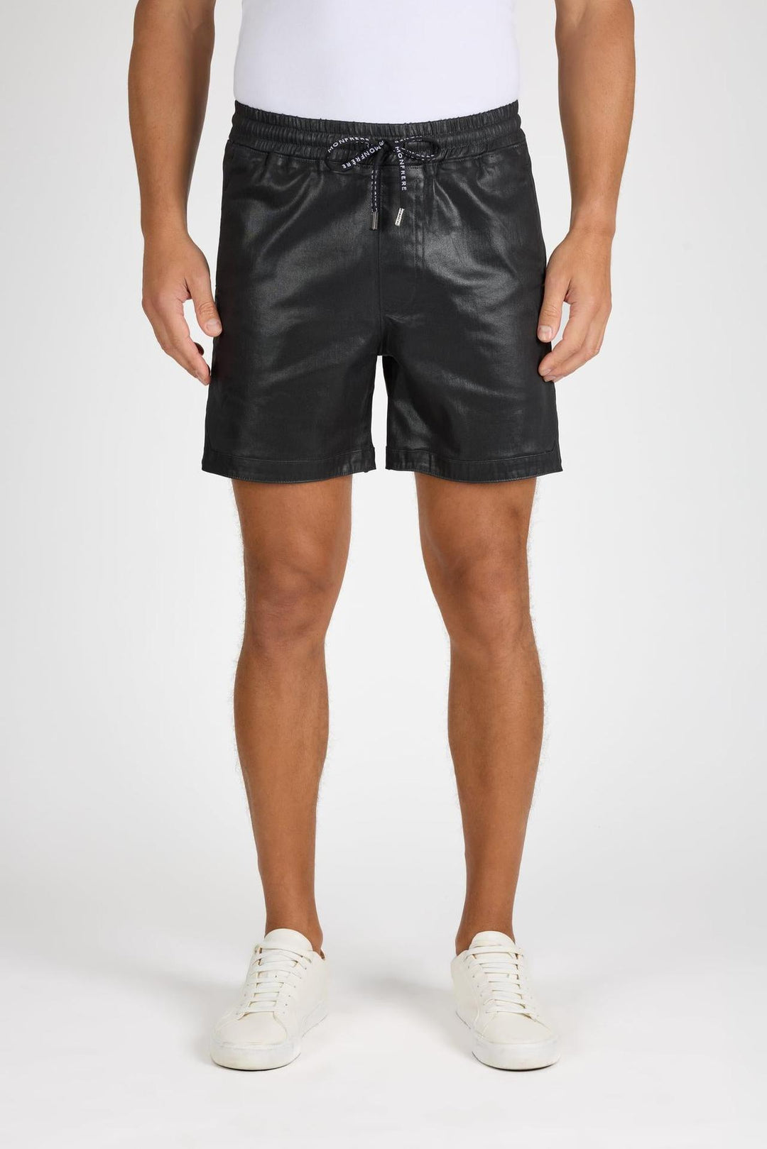 Front profile of MONFRÈRE West Coated Noir men's black stretch sateen tencel twill with a coated finish drawstring short.